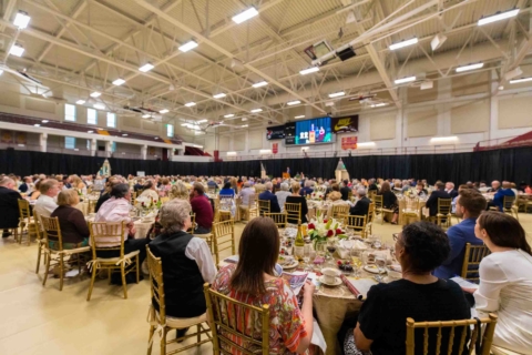 back view of dinner event inside the basketball arena