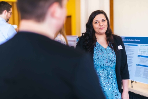 grinning female student looking at male student during Innovation Showcase