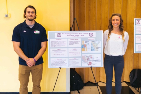 male and female physician assistant students standing with their research poster at the Innovation Showcase