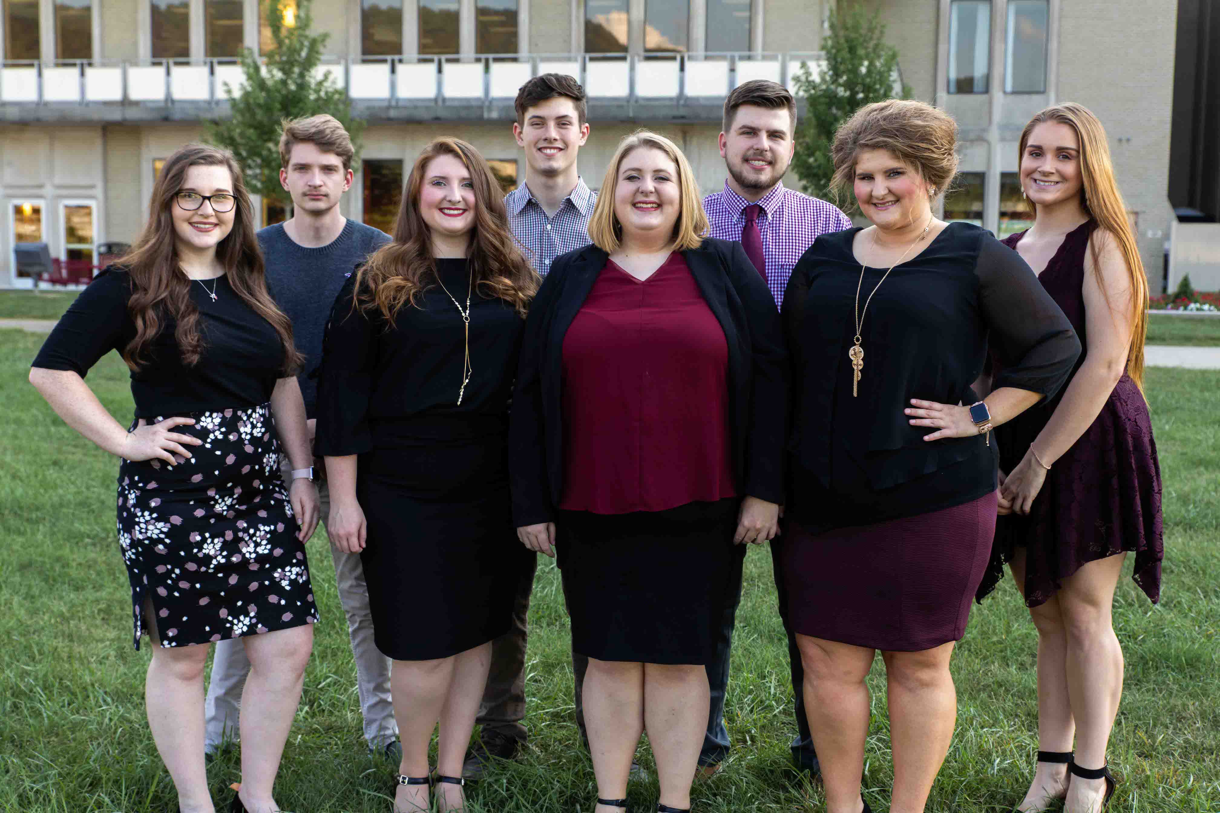 Innovation Scholars in business attire posing for a group photo