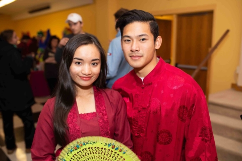 Students posing in traditional dress at international event