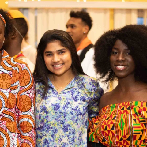 five smiling female students looking at the camera during international festival