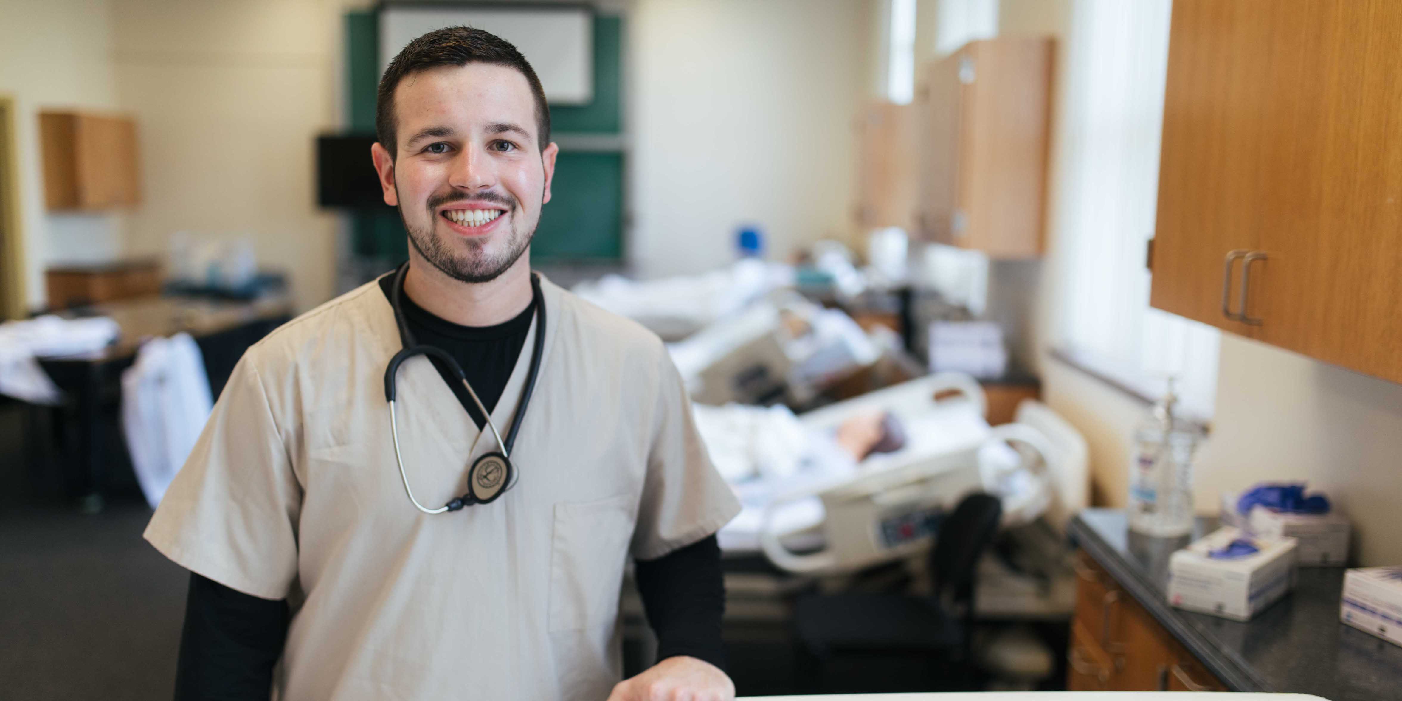 Nursing student in scrubs in simulation lab