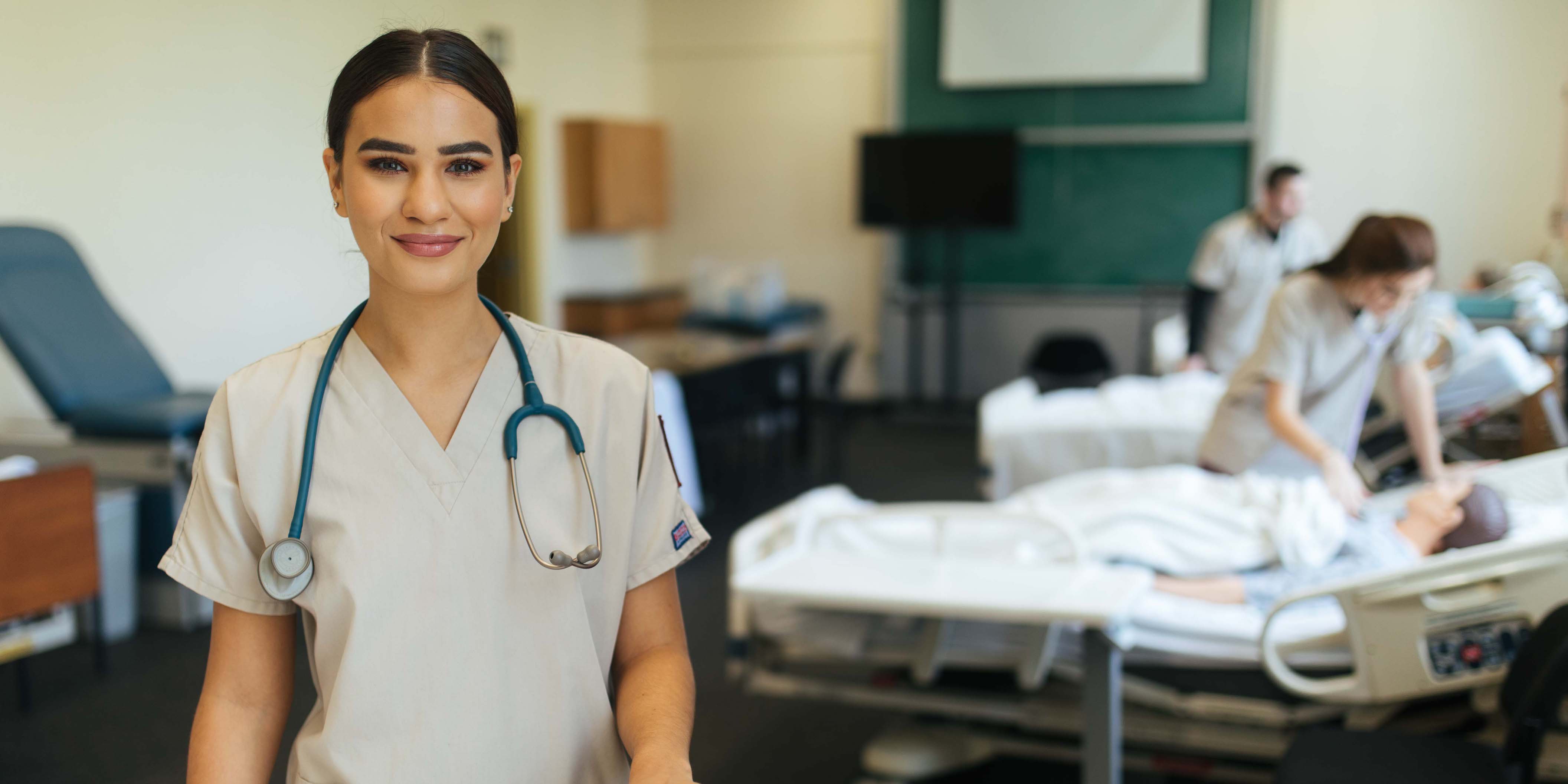 Nursing student in scrubs in simulation lab