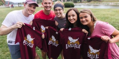group of students posing with EagleFest t-shirts