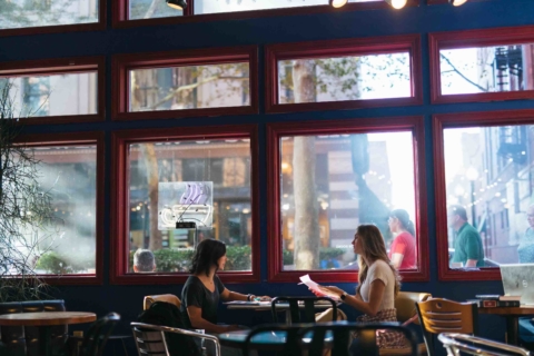 two female students sitting across from each other at a table in Taylor Books downtown