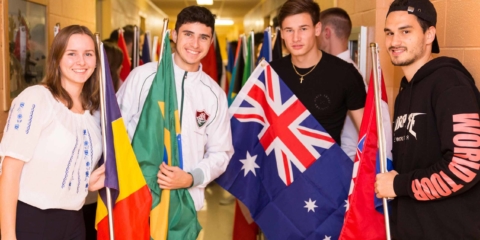 International students posing with international flags
