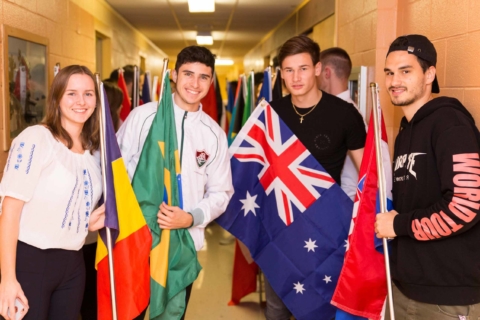 International students posing with international flags