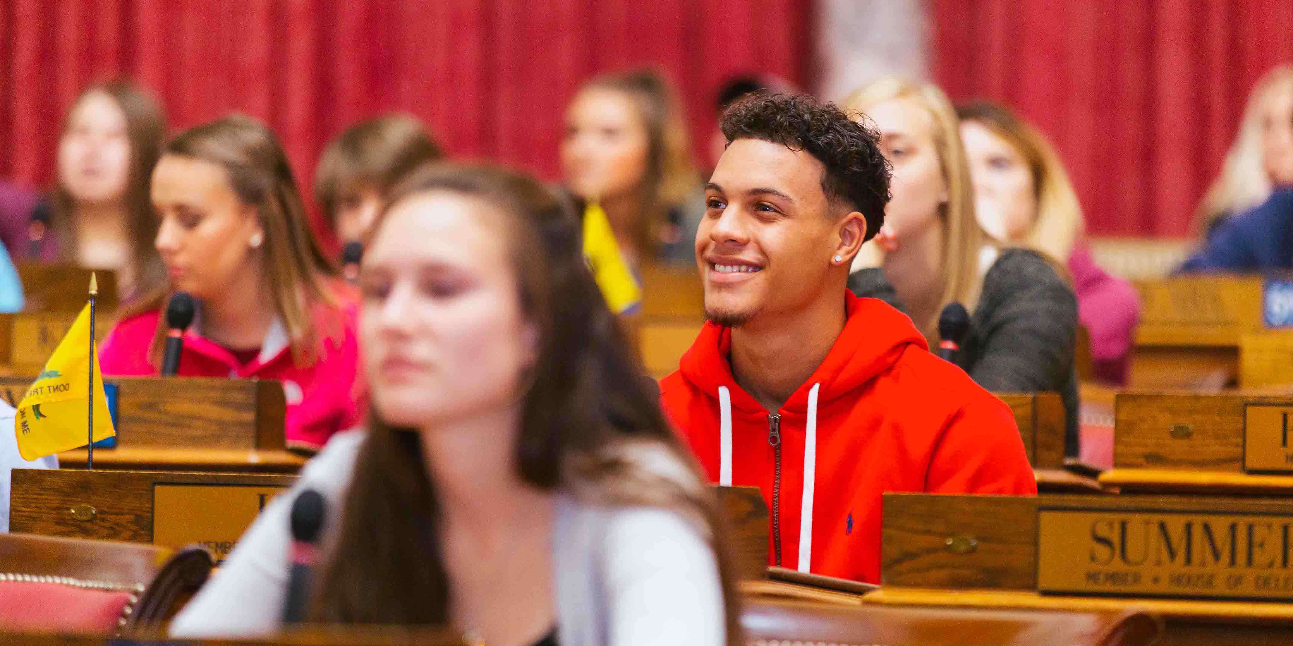 group of students sitting in WV House of Delegates seats in House of Delegates Chamber
