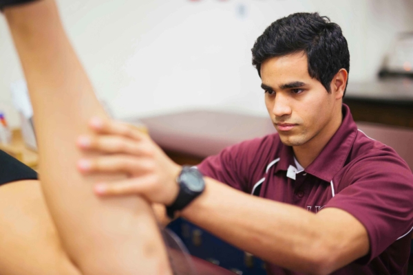 Athletic training student conducting an assessment