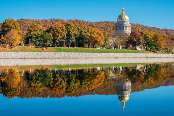 Capitol Dome reflected on river in fall