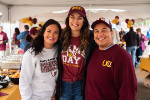 three people posing at Homecoming tailgate party