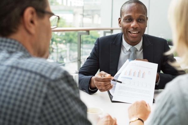 Businessman showing couple data on paper.