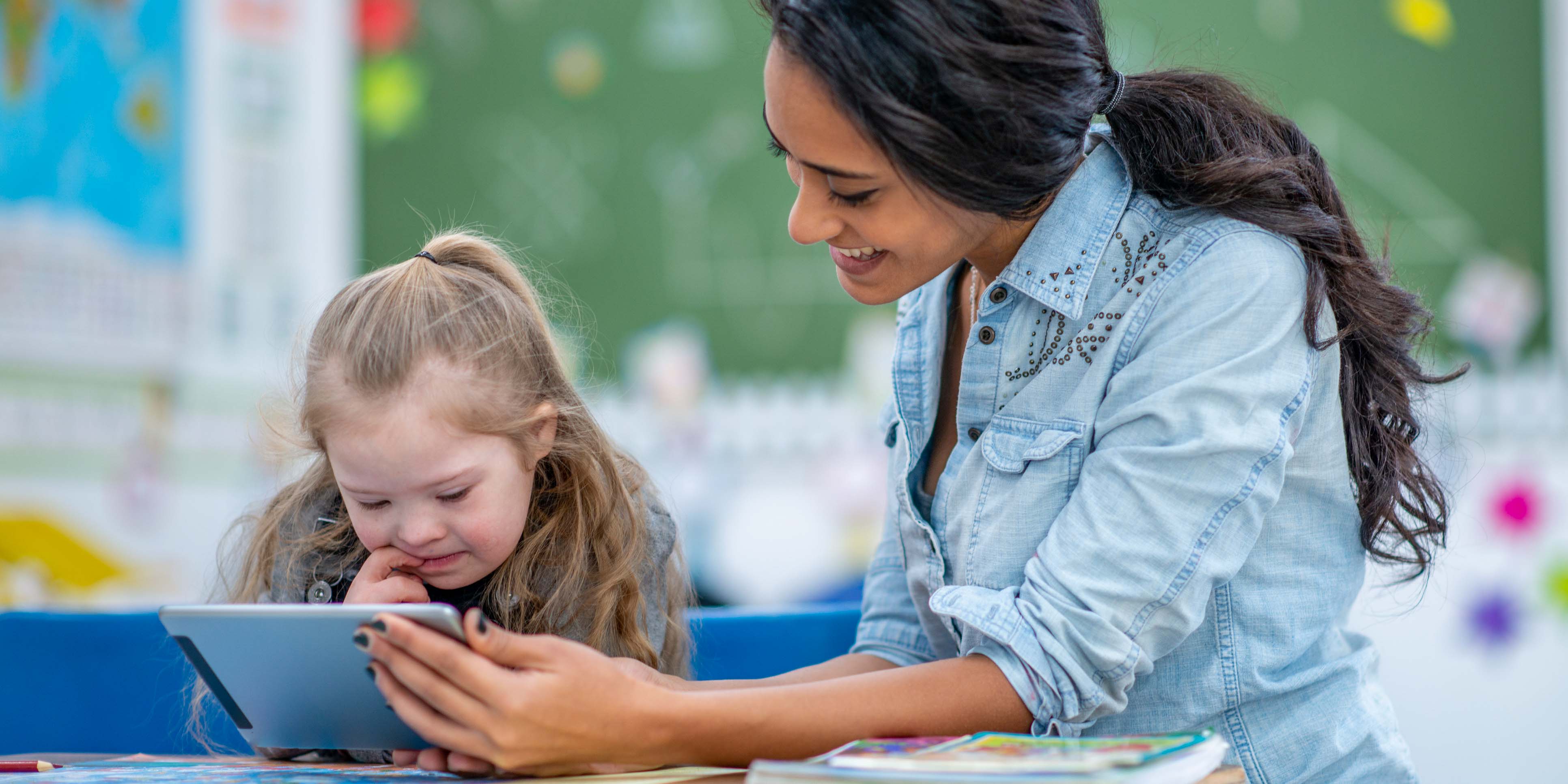 female holding an ipad while child looks at it