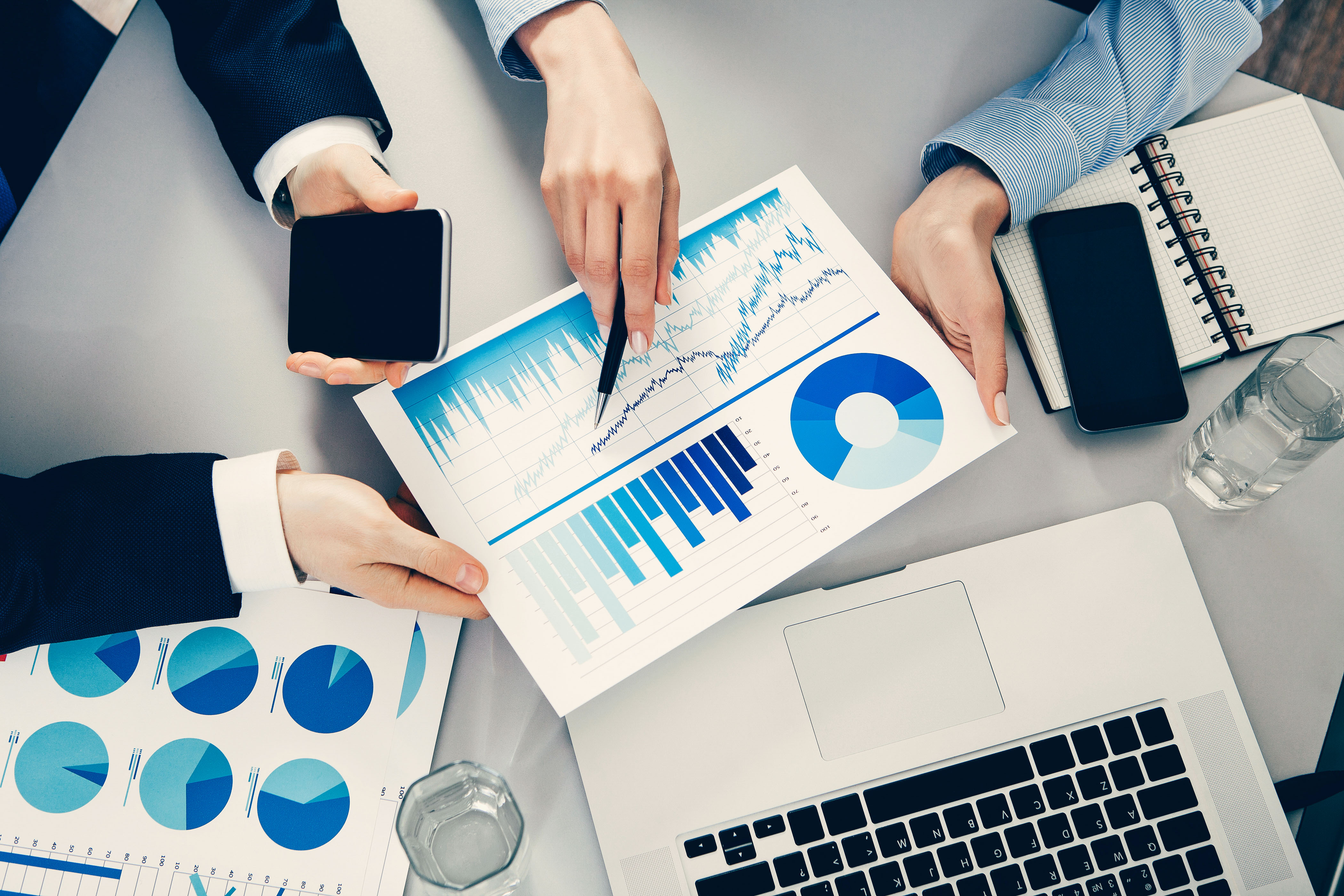 Businessman and businesswoman working on data charts.