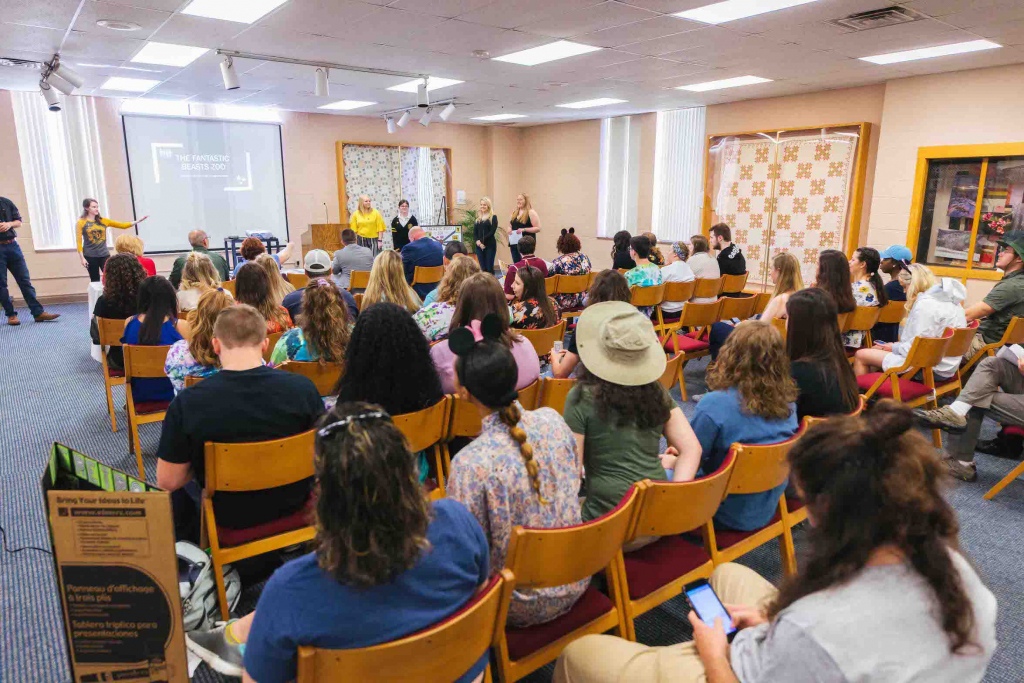 students sitting in chairs listening to presntation