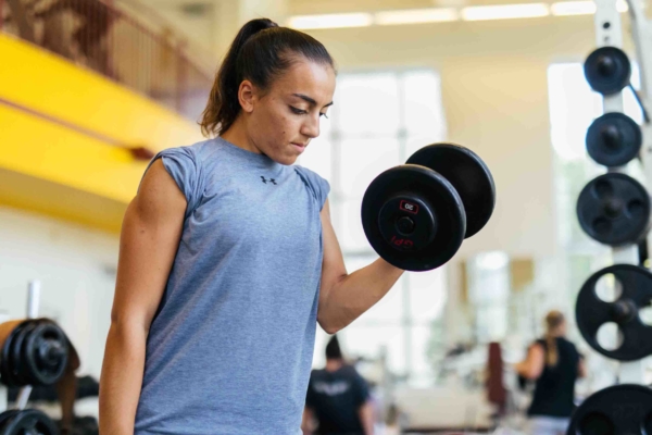 Female in gym lifting weights