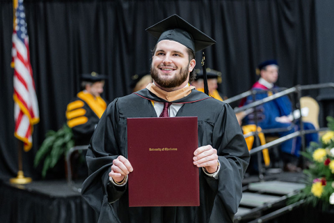 Winter Graduation Student Holding Diploma